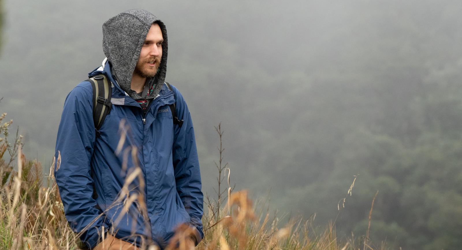 Man standing in foggy mountains